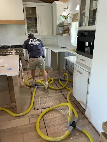 Restoration technician drying a water damaged Altamonte Springs, FL home with air movers